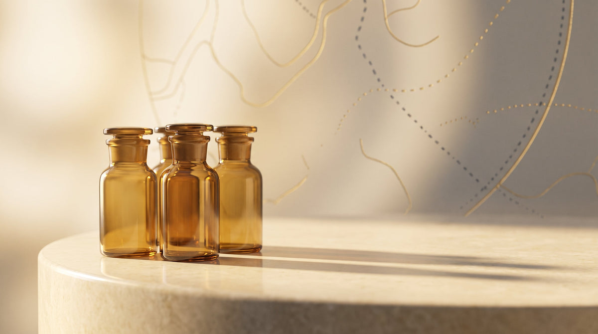 A group of amber research vials on a cream stone surface with a subtle gold delivery-route motif
