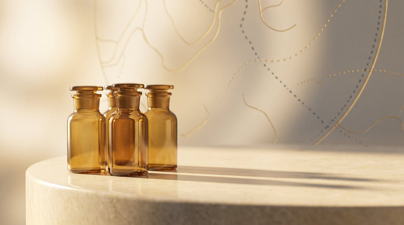 A group of amber research vials on a cream stone surface with a subtle gold delivery-route motif
