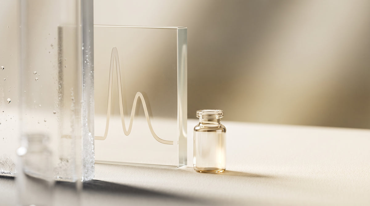 Abstract still-life of a laboratory glass vial and an etched chromatography curve on frosted glass, in warm gold and ivory tones